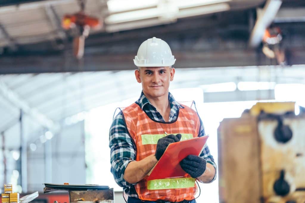 Portrait of engineer foreman in hardhat working on construction
