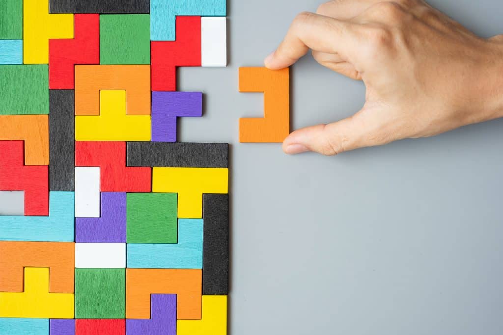 hand connecting geometric shape block
